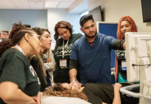 A CRNA provides a demonstration to students.