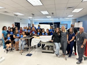 Arizona CRNAs pose with high school students after a workshop.