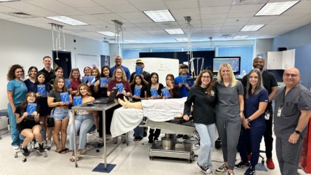 Arizona CRNAs pose with high school students after a workshop.