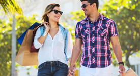 Two people shopping on a sunny day while using AANA Rewards